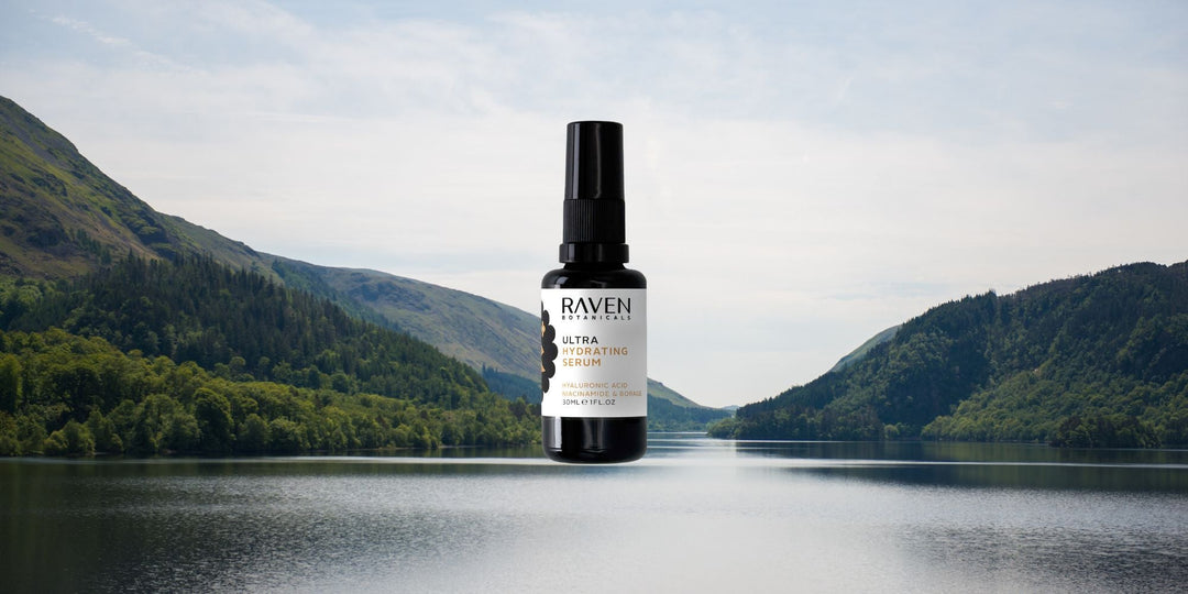 An image of two mountains with a Raven serum bottle in the middle of a lake.