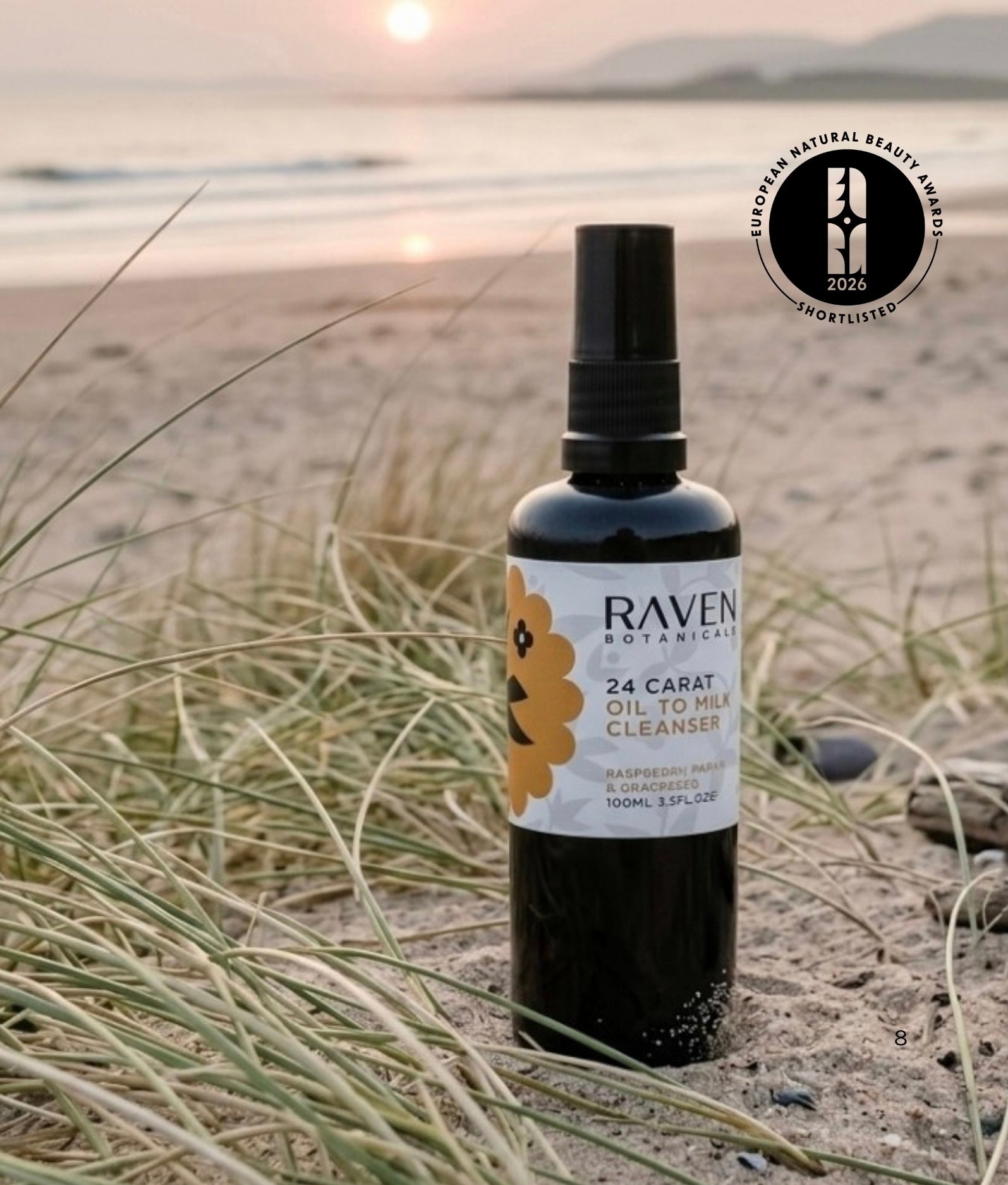 Raven Botanicals 24 Carat Oil-to-Milk Cleanser Sitting on a Scottish beach in the sunset beside marram grass.