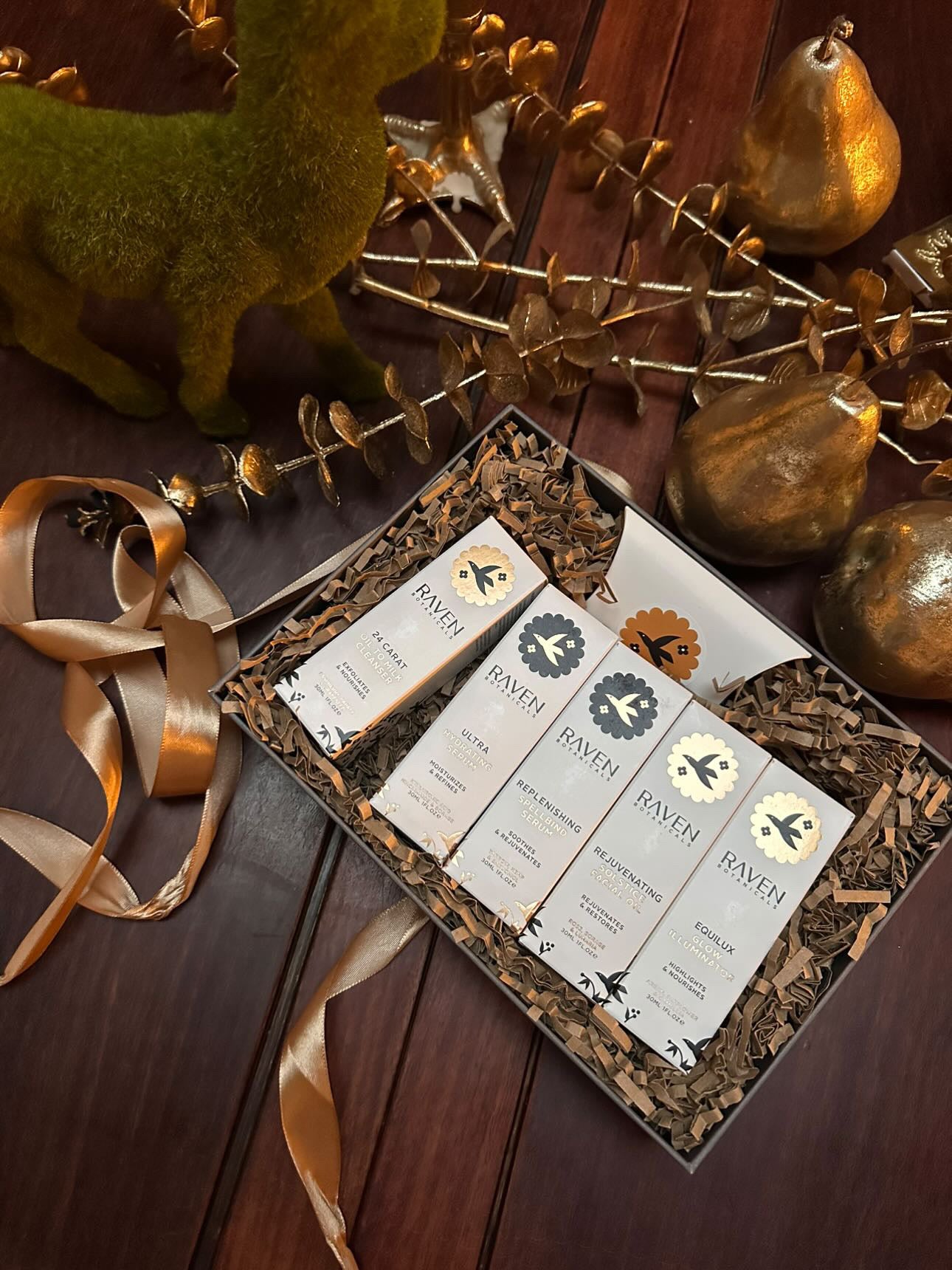 Raven Botanicals luxury Scottish Gift Set on a wooden surface with decorative elements
